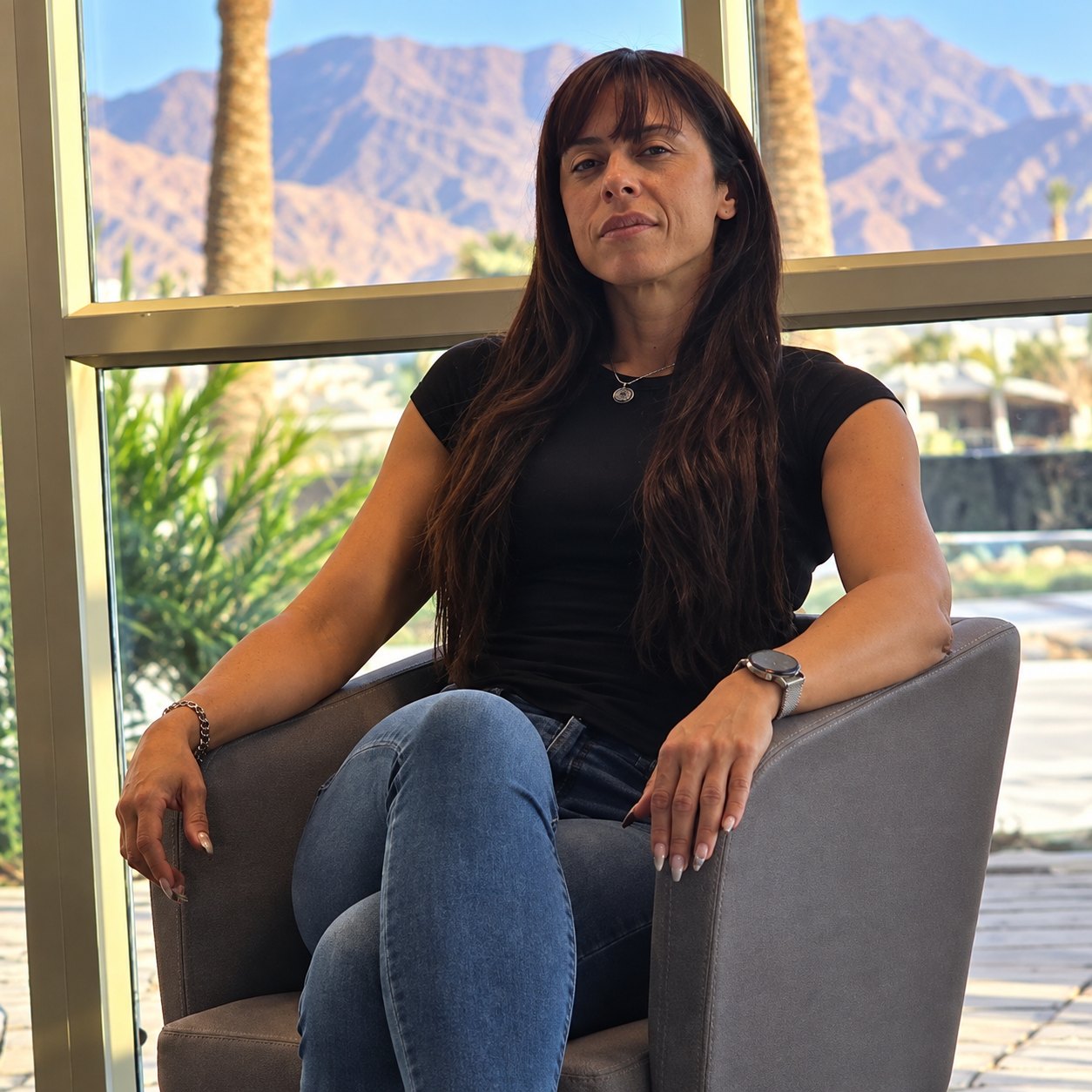 Sayris Athena seated with the Eilat mountains behind her
